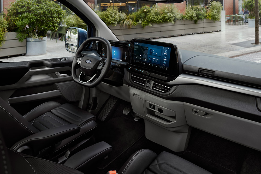 L'intérieur du Ford Tourneo Custom, montrant le siège du conducteur, le tableau de bord et la console centrale.